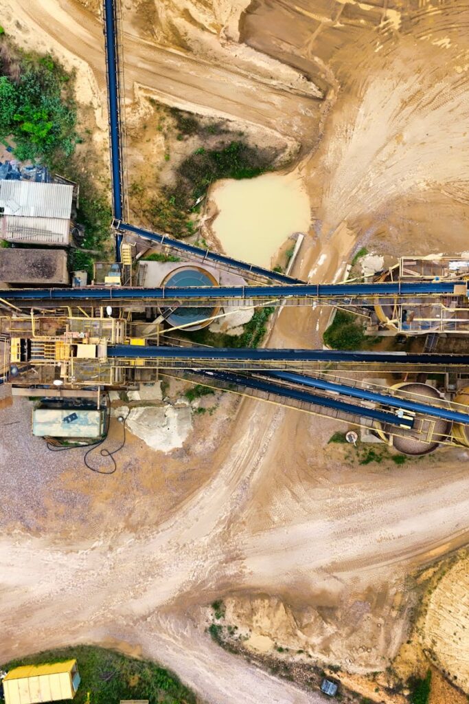 Top-down view of a sprawling industrial mining site featuring heavy machinery and detailed terrain.